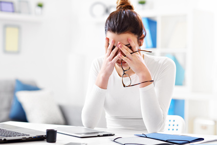 Woman in distress at her desk. 