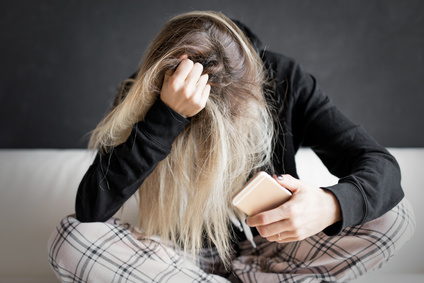 Woman clutching her own hair in frustration.